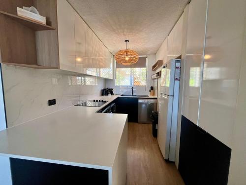 a kitchen with white counters and a white counter top at Park Towers-Goodwin Towers Holiday Units in Gold Coast