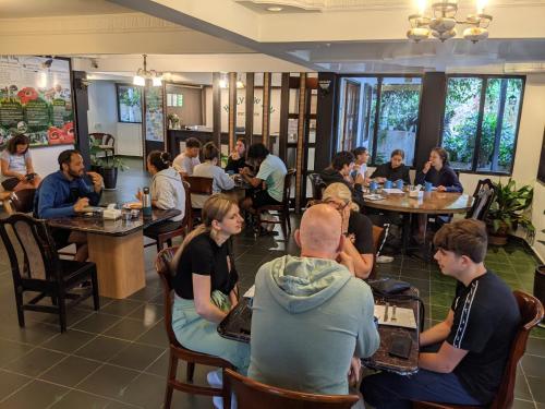 a group of people sitting at tables in a restaurant at Hillview Inn Cameron Highlands PROMO in Tanah Rata