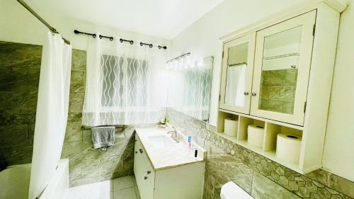 a bathroom with a sink and a mirror at Amazing Home Near Toronto Airport with 2 Parking in Toronto
