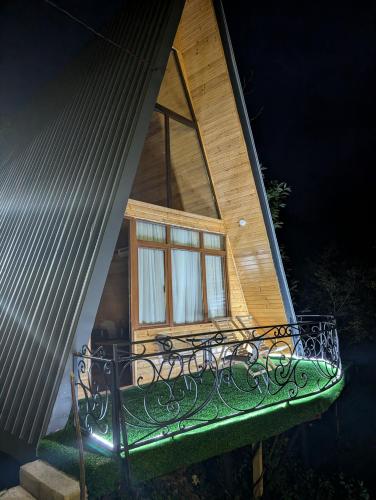 a small house with a bench and a window at Prime House Cottages in Keda