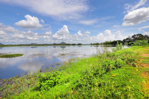 a large body of water with clouds in the sky at Lake Lower Hotel & Yala Safari in Tissamaharama