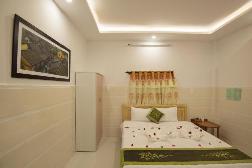 a bedroom with a bed in a room at Bong House Homestay 2 in Hoi An
