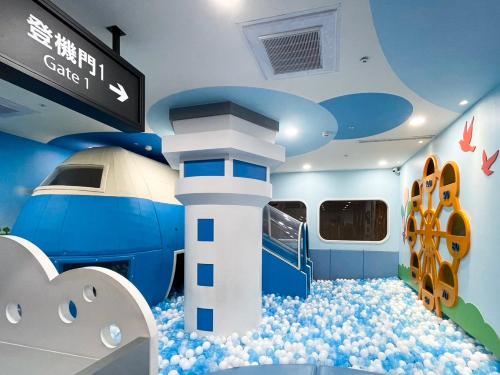 a room with a train with a lighthouse and clouds at Holiday Garden Hotel SKM Park in Kaohsiung
