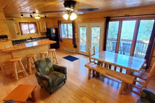 a dining room and kitchen with a table and chairs at Lakeside 2 Bedroom Wolfs Den Cabin On Kab in Kabetogama