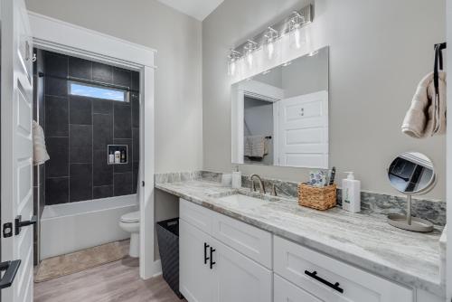 a white bathroom with a sink and a toilet at Luxury Retreat near St. Andrews in Panama City Beach