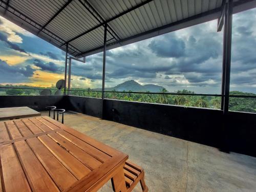 a room with a table and a view of mountains at Catch Up Dambulla in Dambulla