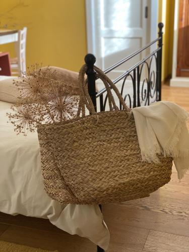 a basket sitting on the side of a bed at B&B MELLONI STREET in Dolo