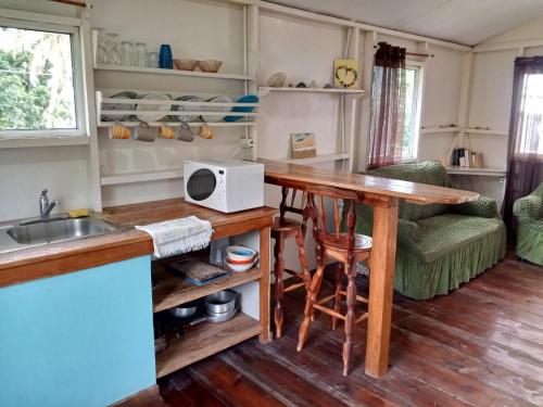 a kitchen with a table and a counter top at Christina's Guest House OFFICIAL in Little Corn Island