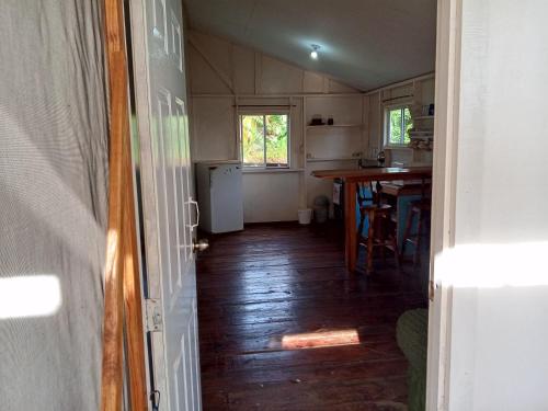 an open door to a kitchen with a wooden floor at Christina's Guest House OFFICIAL in Little Corn Island