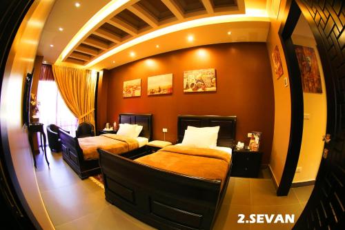 a bedroom with two beds in a room at Layali Al Shams Hotel in ‘Anjar