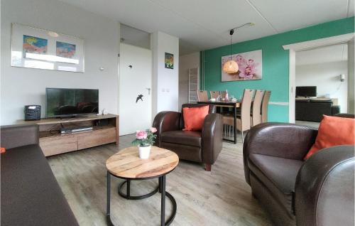 a living room with two couches and a table at Lovely Home In Vlagtwedde With Kitchen in Vlagtwedde