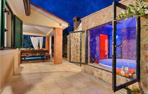 a bathroom with a tub in a stone wall at Villa Valencan in Rovinj