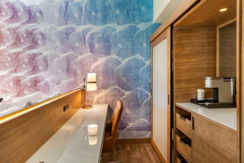 a kitchen with a large mural on the wall at Cambria Hotel Manchester South Windsor in South Windsor