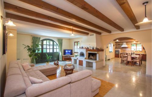 a living room with a couch and a fireplace at Villa Kringa in Kučići