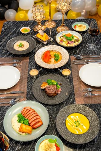 a table with plates of food on a table at Love St - Hanoi Hotel in Hanoi