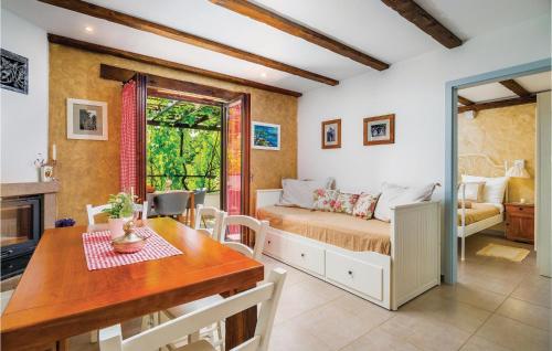 a bedroom with a bed and a table and a dining room at Nice Home In Cres With Wifi in Cres