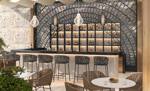 a restaurant with tables and chairs and a bar at Ruins Luxury Resort - Adults Only in Yalıkavak