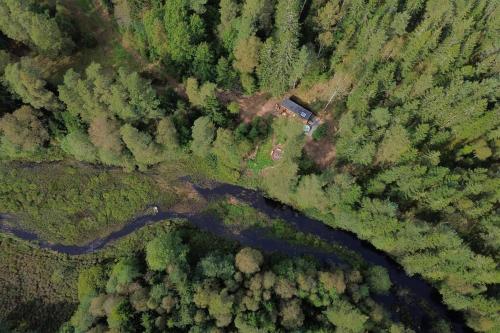 an overhead view of a river in a forest at Freyja Summer Forest Retreat Cabin with Private Outdoor Tub and Lakeside Views in Örby