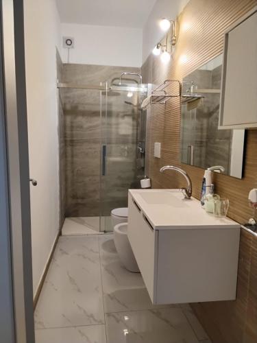 a bathroom with a toilet and a sink and a shower at B&B Passione Salento in Surbo