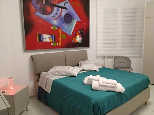 a bedroom with a bed with towels on it at B&B Passione Salento in Surbo