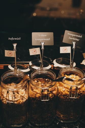 a group of jars filled with food on a table at Hotel Tyrol am Haldensee in Haldensee