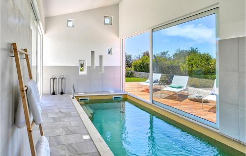 an indoor swimming pool in a house with a patio at Villa Vela Muline in Zadar