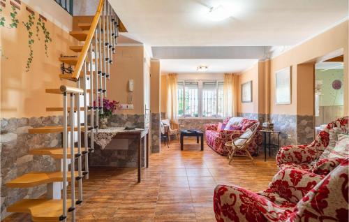 a living room with red chairs and a staircase at Lovely Home In Chiclana De La Fronter in Chiclana de la Frontera