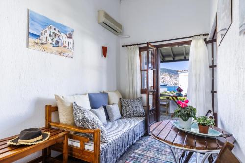 a living room with a couch and a table at Studios Elpiniki in Skopelos Town