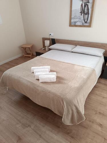 a bedroom with a bed with two towels on it at Apartamento Barbadillo - Redmansur in Cáceres