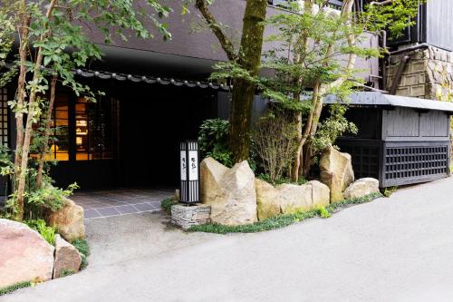 a building with a trash can in front of a building at Yusai Bekkan in Minamioguni