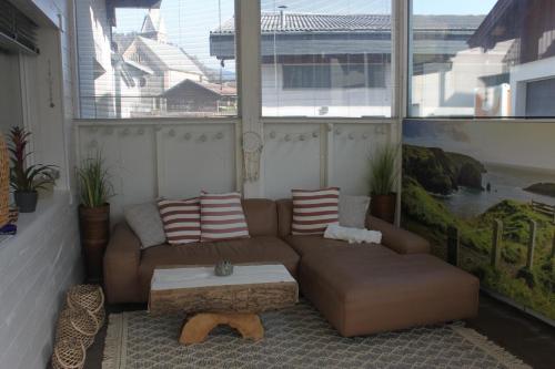 a living room with a couch and a coffee table at Penthouse Julia nähe Badesee mit Infrarotsauna -Zell am See Kaprun in Niedernsill