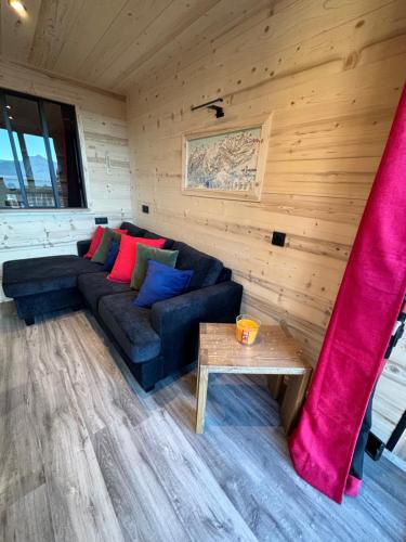 a living room with a couch and a table at Les appartements de Makalu Val Thorens in Val Thorens