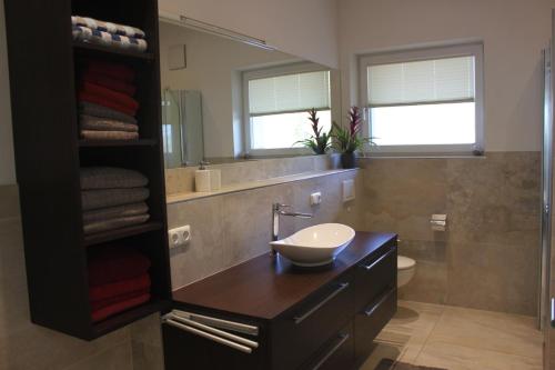 a bathroom with a sink and a mirror at Penthouse Julia nähe Badesee mit Infrarotsauna -Zell am See Kaprun in Niedernsill