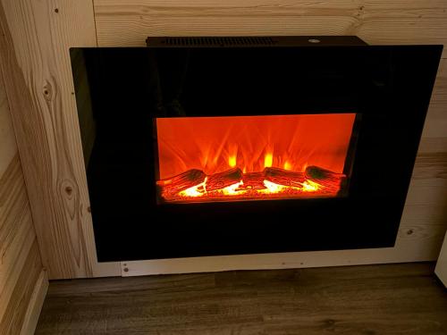 a fire in a fireplace in a room at Les appartements de Makalu Val Thorens in Val Thorens