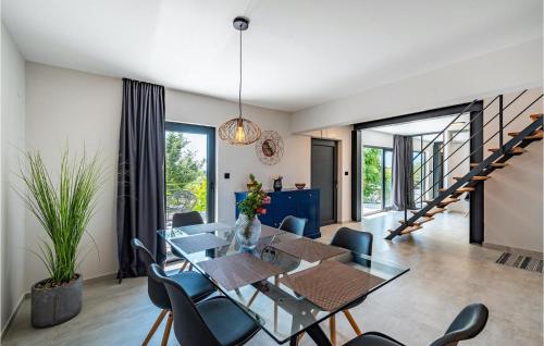 a dining room with a glass table and chairs at Villa Black Wood in Zadar