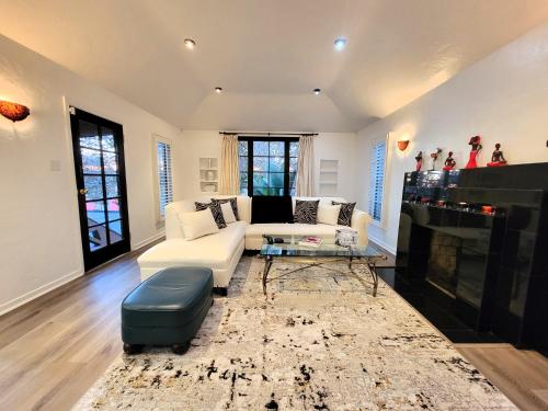 a living room with a white couch and a fireplace at 3 bedroom top story apartment near Pico blvd in Los Angeles