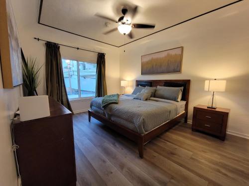 a bedroom with a bed and a ceiling fan at 3 bedroom top story apartment near Pico blvd in Los Angeles