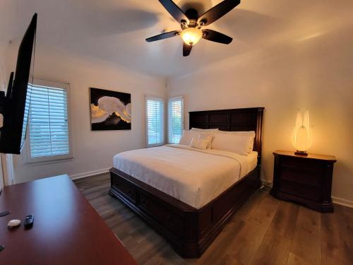 a bedroom with a bed and a ceiling fan at 3 bedroom top story apartment near Pico blvd in Los Angeles