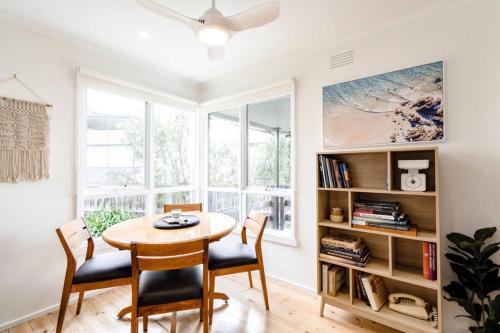 a dining room with a table and chairs and a window at Bellarine Retreat - Pet friendly in Portarlington