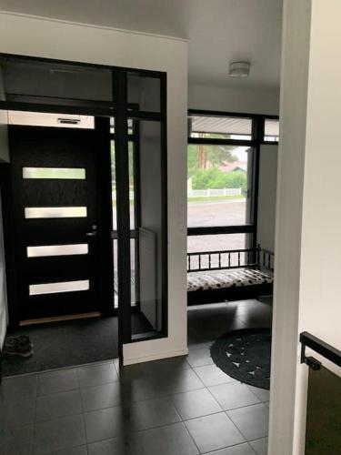 a room with a door and a view of a porch at Villa Venetsia tilava huvila in Lapua