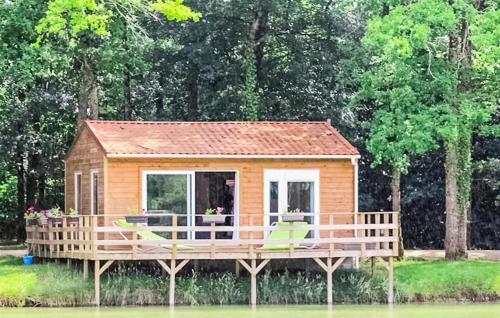 a tiny house on a dock in the water at Awesome Stacaravan In Chef-Boutonne in Chef-Boutonne