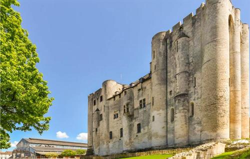 an old castle with a blue sky in the background at Awesome Stacaravan In Chef-Boutonne in Chef-Boutonne