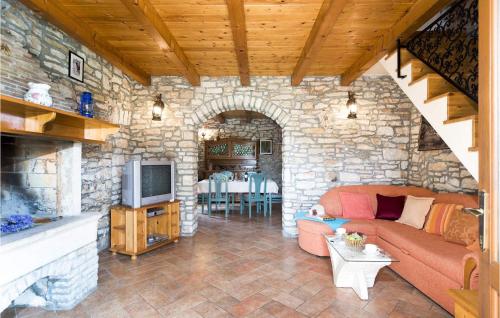 a living room with a couch and a stone wall at Villa Petric in Pula