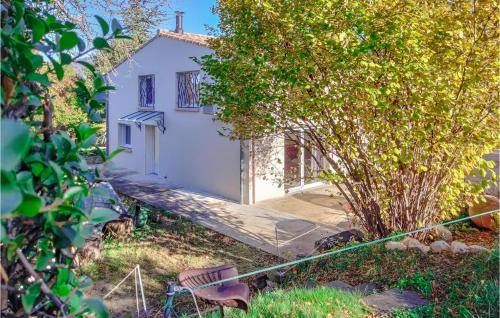 a white house with a tree in front of it at Lovely Home In Villes-Sur-Auzon in Villes-sur-Auzon