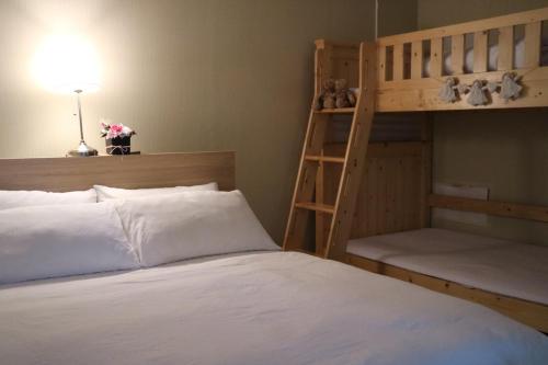 a bedroom with two bunk beds and a ladder at Mr. Kim Guesthouse in Incheon
