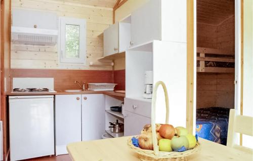 a kitchen with a basket of fruit on a table at Gorgeous Stacaravan In Chef-Boutonne in Chef-Boutonne