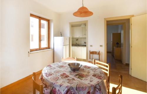 a kitchen and dining room with a table and chairs at Cozy Apartment In Nocera Terinese in Nocera Terinese