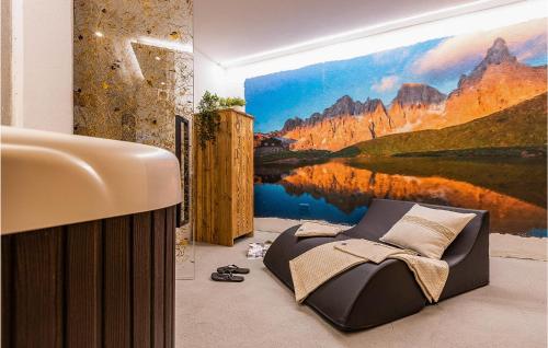 a bedroom with a painting of a lake and mountains at Chalet Luisa in Predazzo
