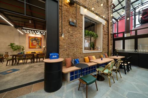 a restaurant with tables and chairs and a brick wall at AMOY by Far East Hospitality in Singapore