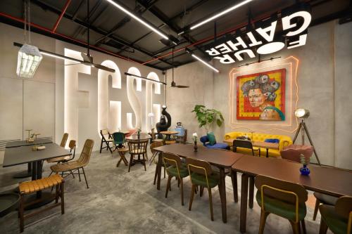a dining room with tables and chairs and a painting at AMOY by Far East Hospitality in Singapore